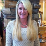 lady standing with long straight blonde hair in salon